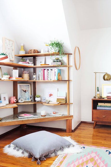 corner shelves and corner desk create a home office in small spaces