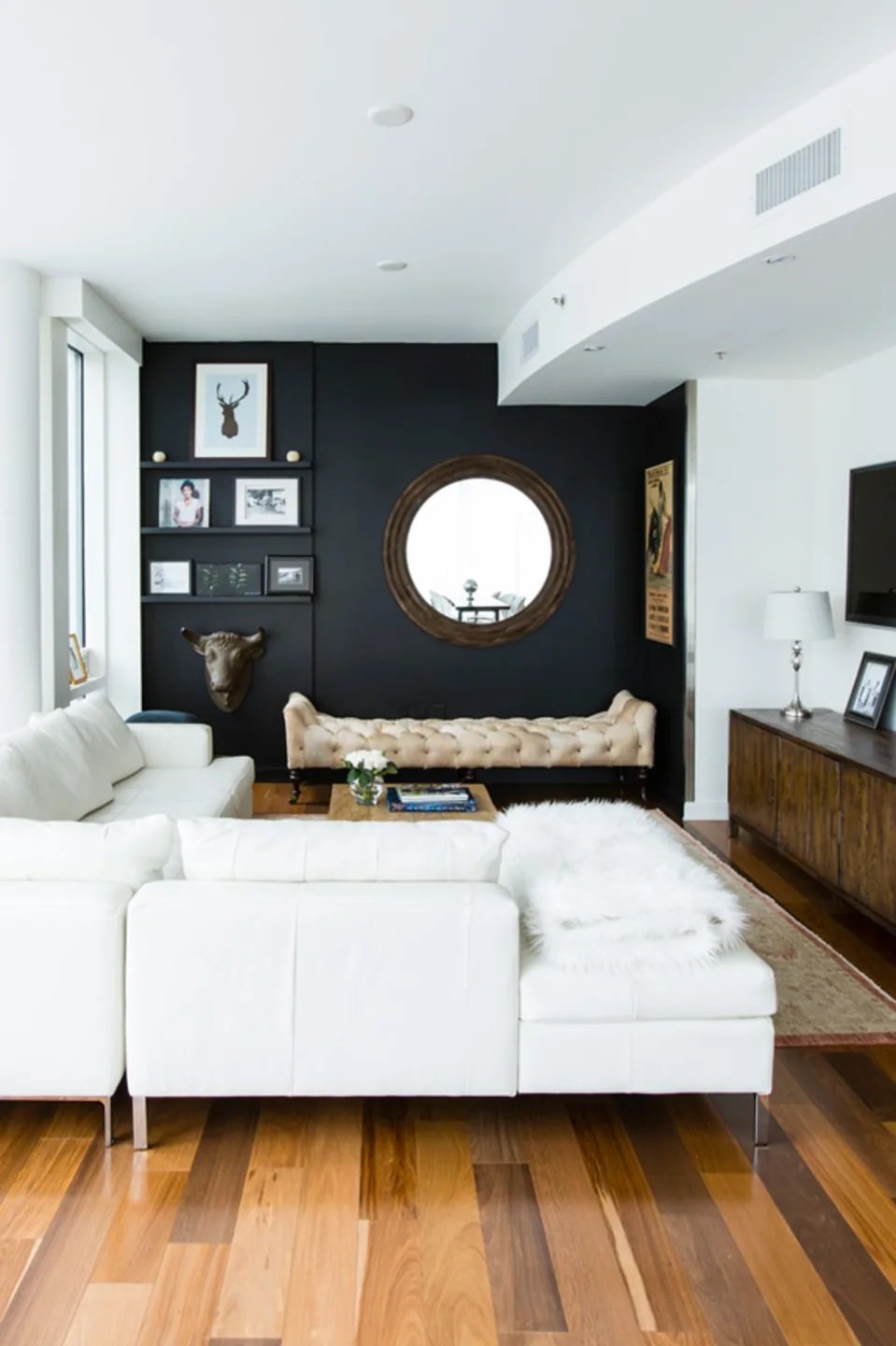 black accent wall and white furniture in small living room