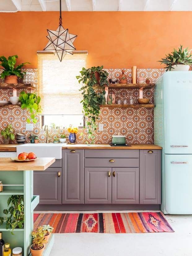 bold small boho kitchen with orange walls 