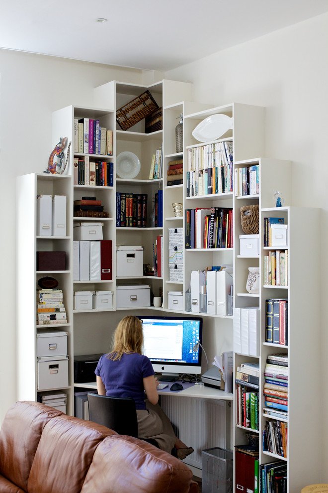 small office nook with tall bookshelves