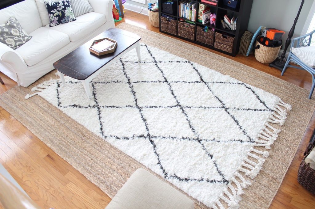 layered neutral rugs in studio apartment