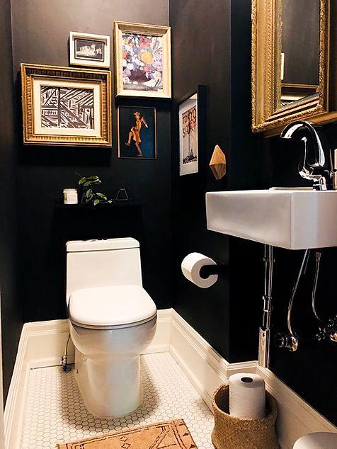 dark moody powder room with gold accents